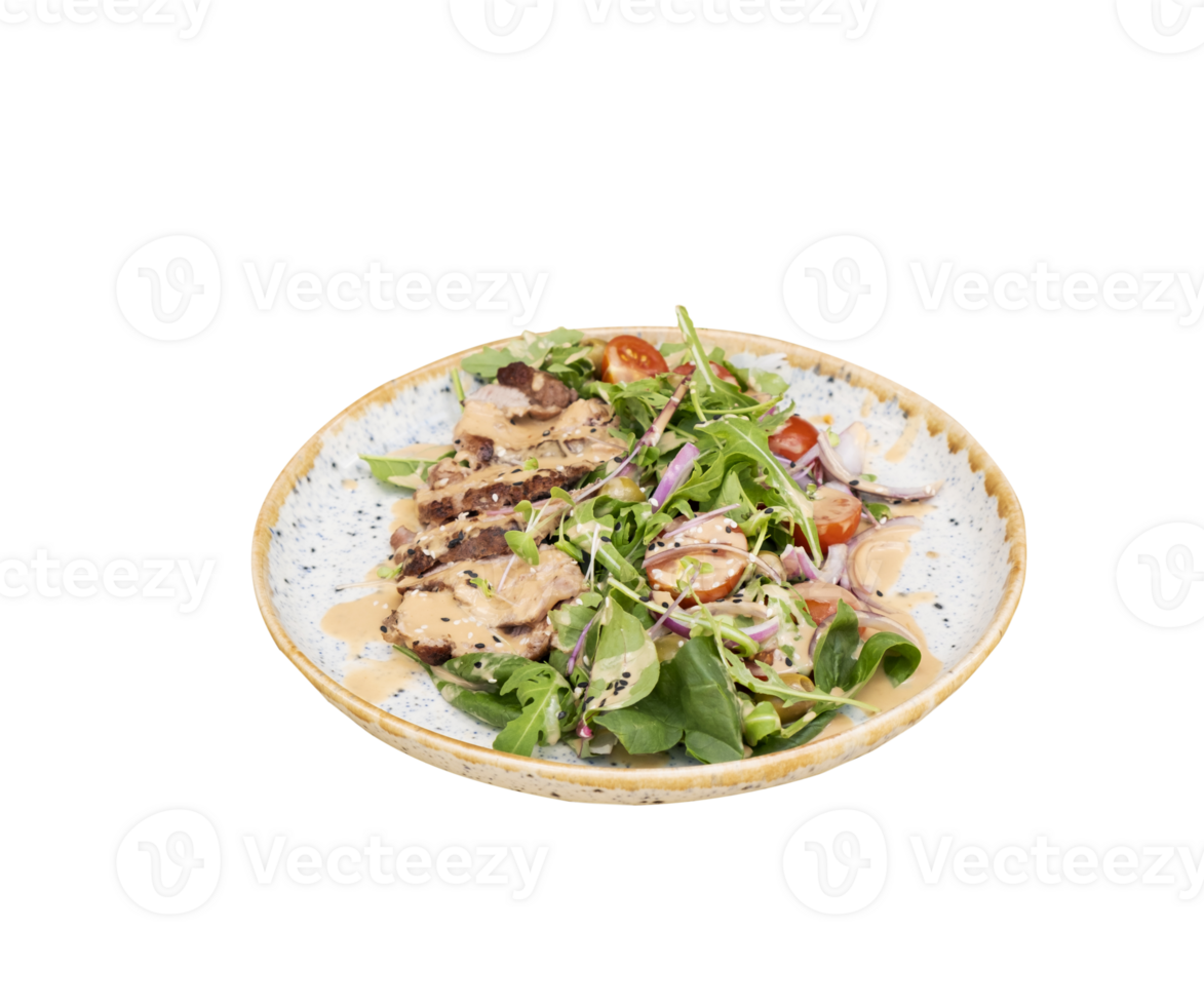 A plate with veal meat on greens with vegetables and olives under nut sauce on a wooden table top view isolated on transparent background. png