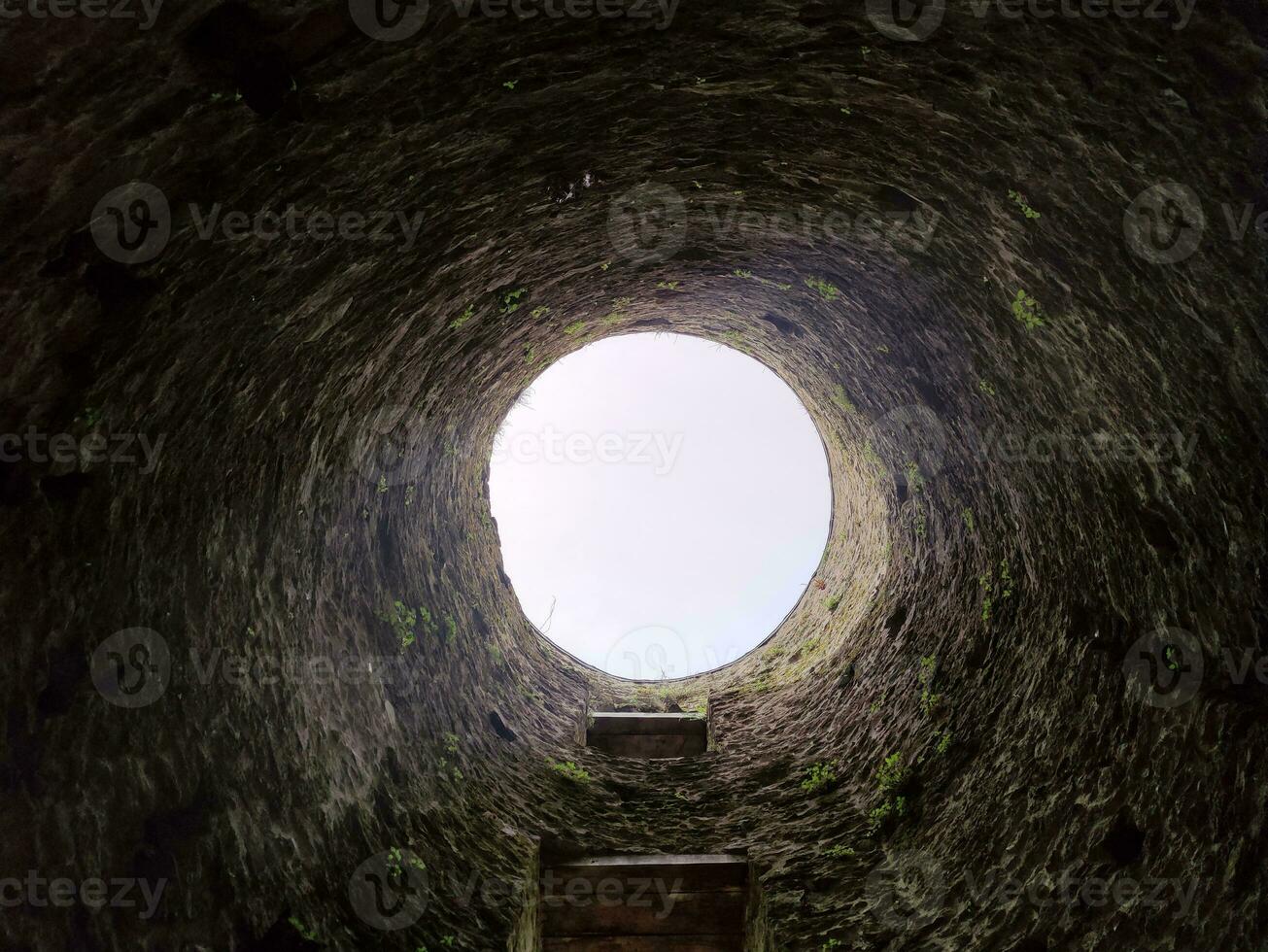 Stone well hole, old construction from inside, fall down in the well photo