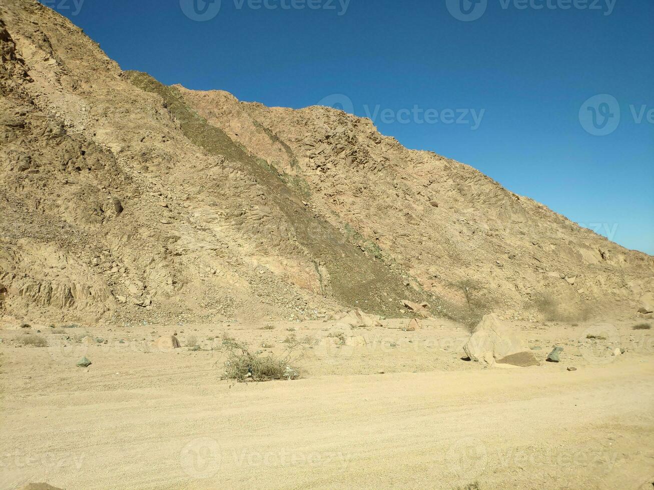 Desert land with mountains and sea photo