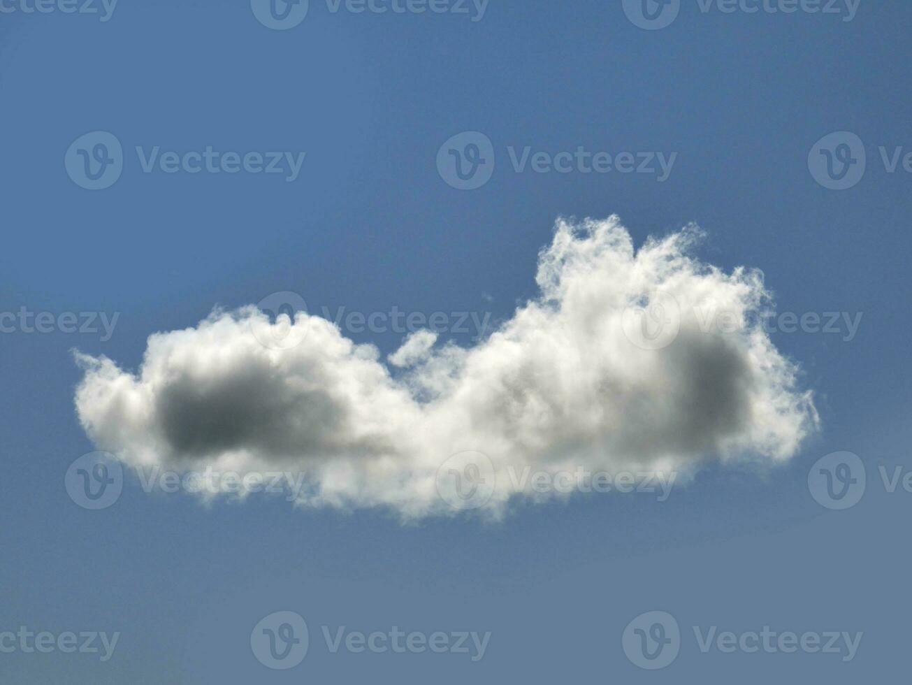 Single white cloud over blue sky background. Fluffy cumulus cloud shape photo