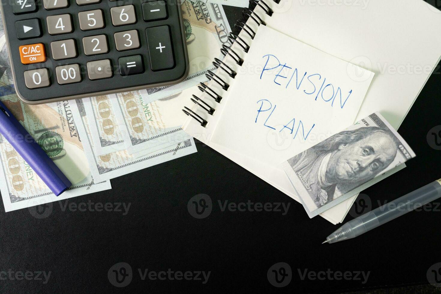 Paper note with text PENSION PLAN with stationery and dollar on desk. Pension Plan. Retirement concept. Pension calculation concept. photo