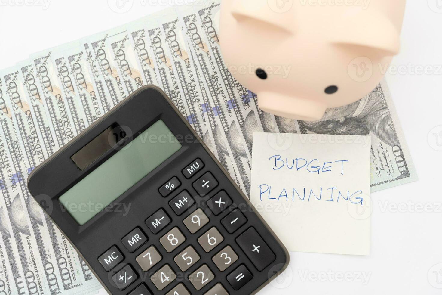Money budget planning. Piggy bank with calculator on Dollars in isolated background. Finance and business concept. photo