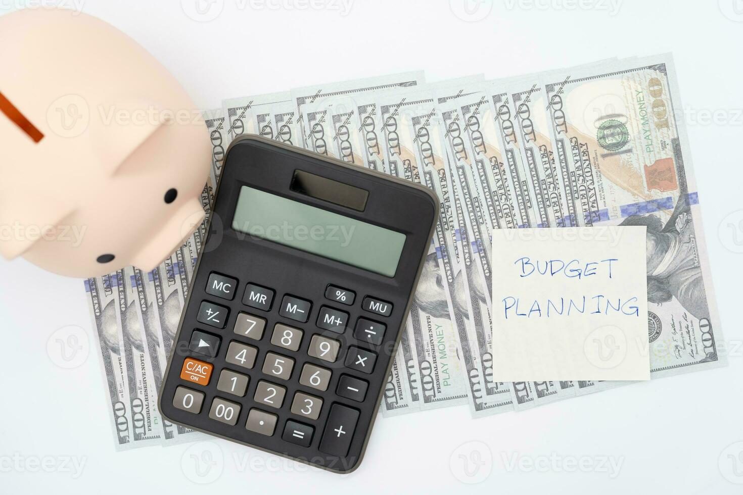Money budget planning. Piggy bank with calculator on Dollars in isolated background. Finance and business concept. photo