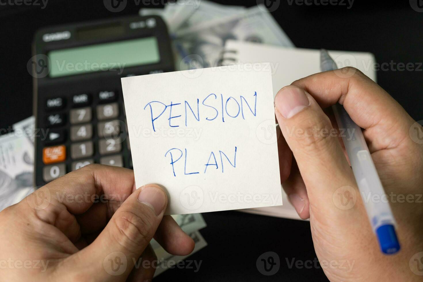 Paper note with text written PENSION PLAN, Calculator, Pen. Investments Concept. Pension Plan. Retirement concept. Pension calculation concept. photo