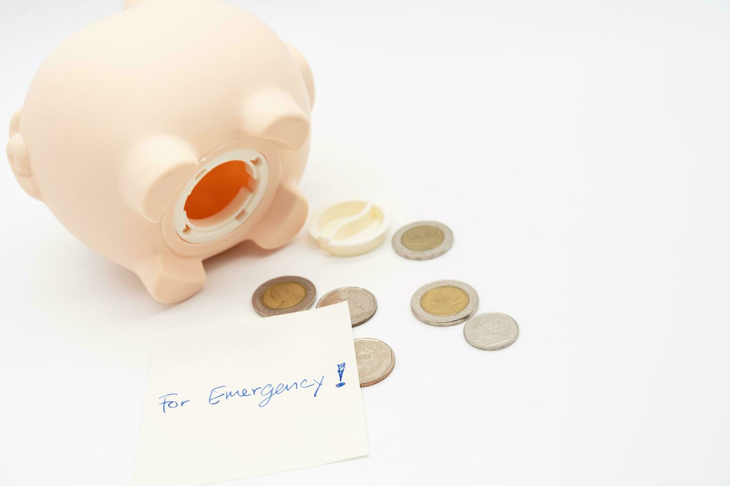 For Emergency written on the notes with open piggy bank. Concept of money saving for rainy day. Business and finance concept. photo