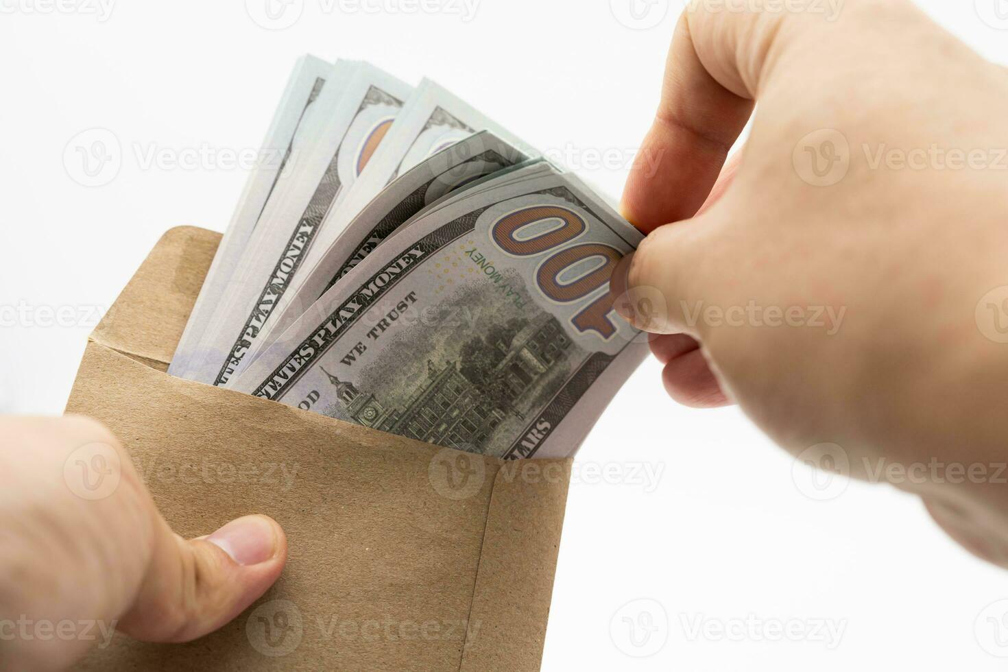 Hands Holding Envelope With Money And Copy Space. opens envelope with money, dollars, currency, holds in hands. isolated background. photo