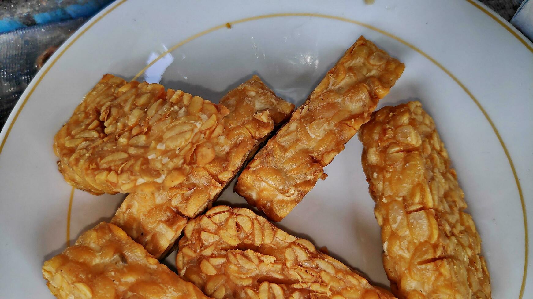 Indonesian traditional meal named Tempe Goreng or fried tempe photo