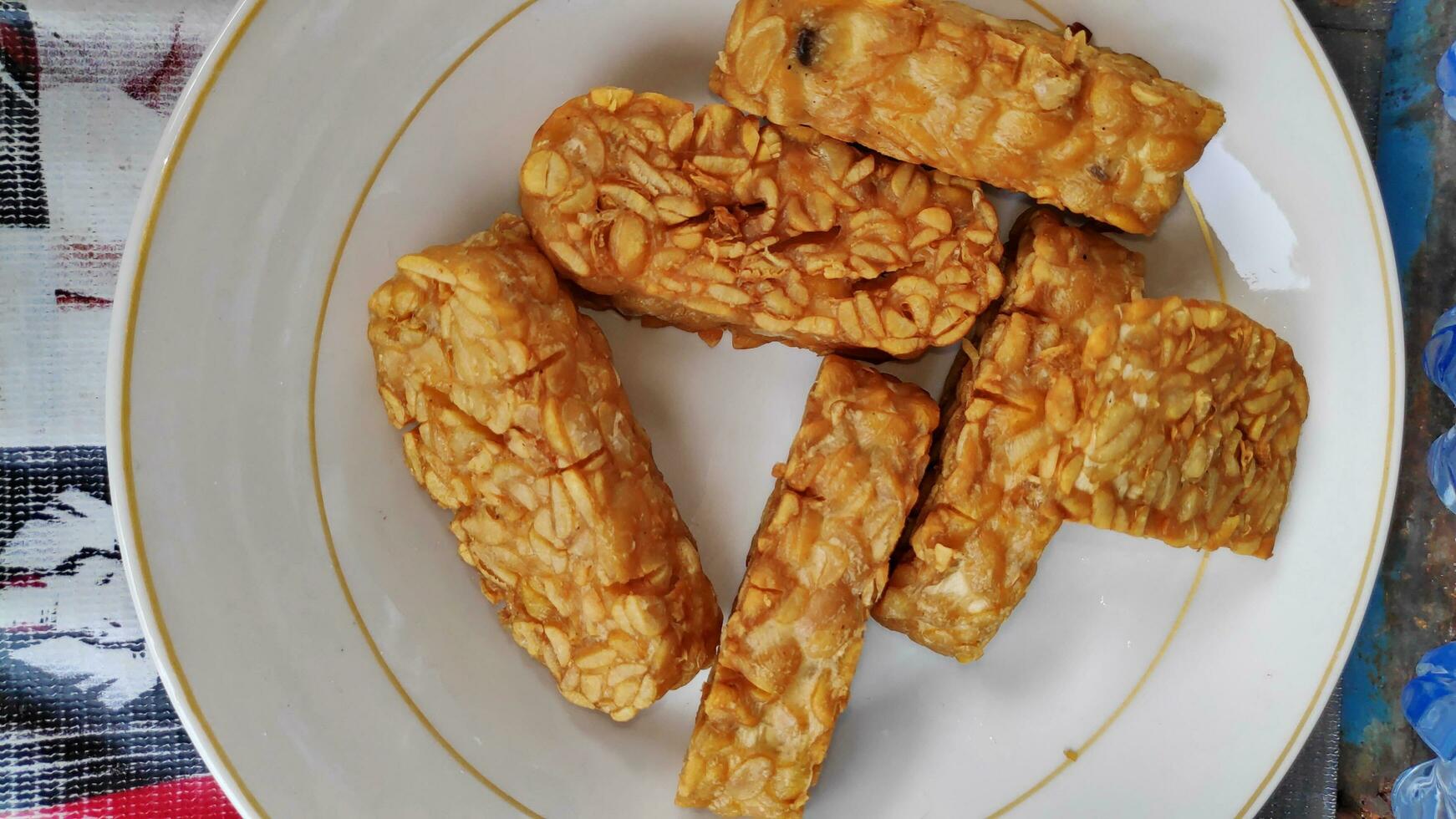 Indonesian traditional meal named Tempe Goreng or fried tempe photo