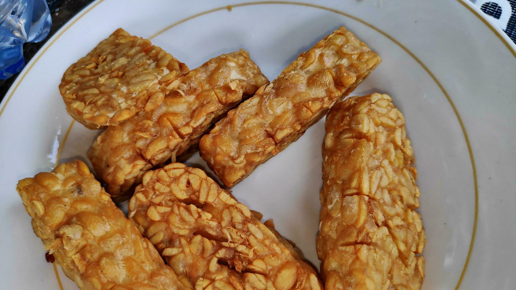 Indonesian traditional meal named Tempe Goreng or fried tempe photo