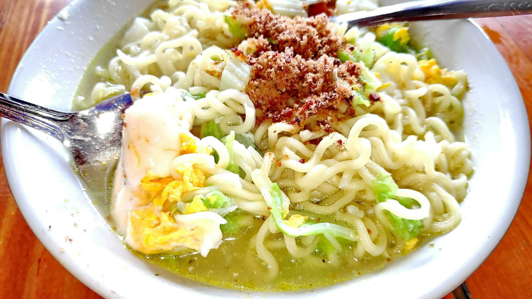 indonesian favourite instant noodle, soto flavour ready to eat photo