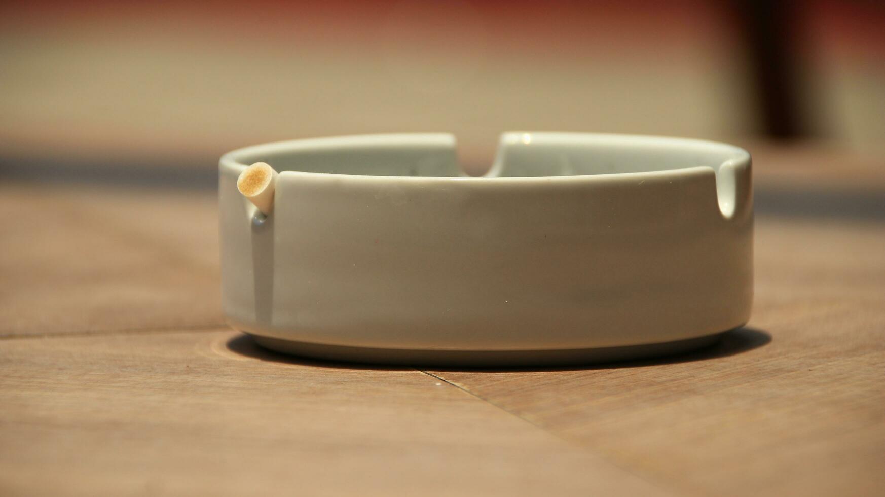 Closeup of empty ashtray with blurred background photo
