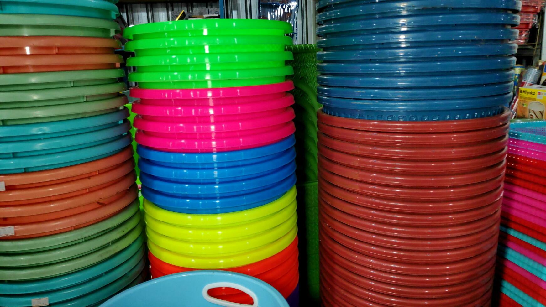 Cheap plastic household items for sale on the market close up photo