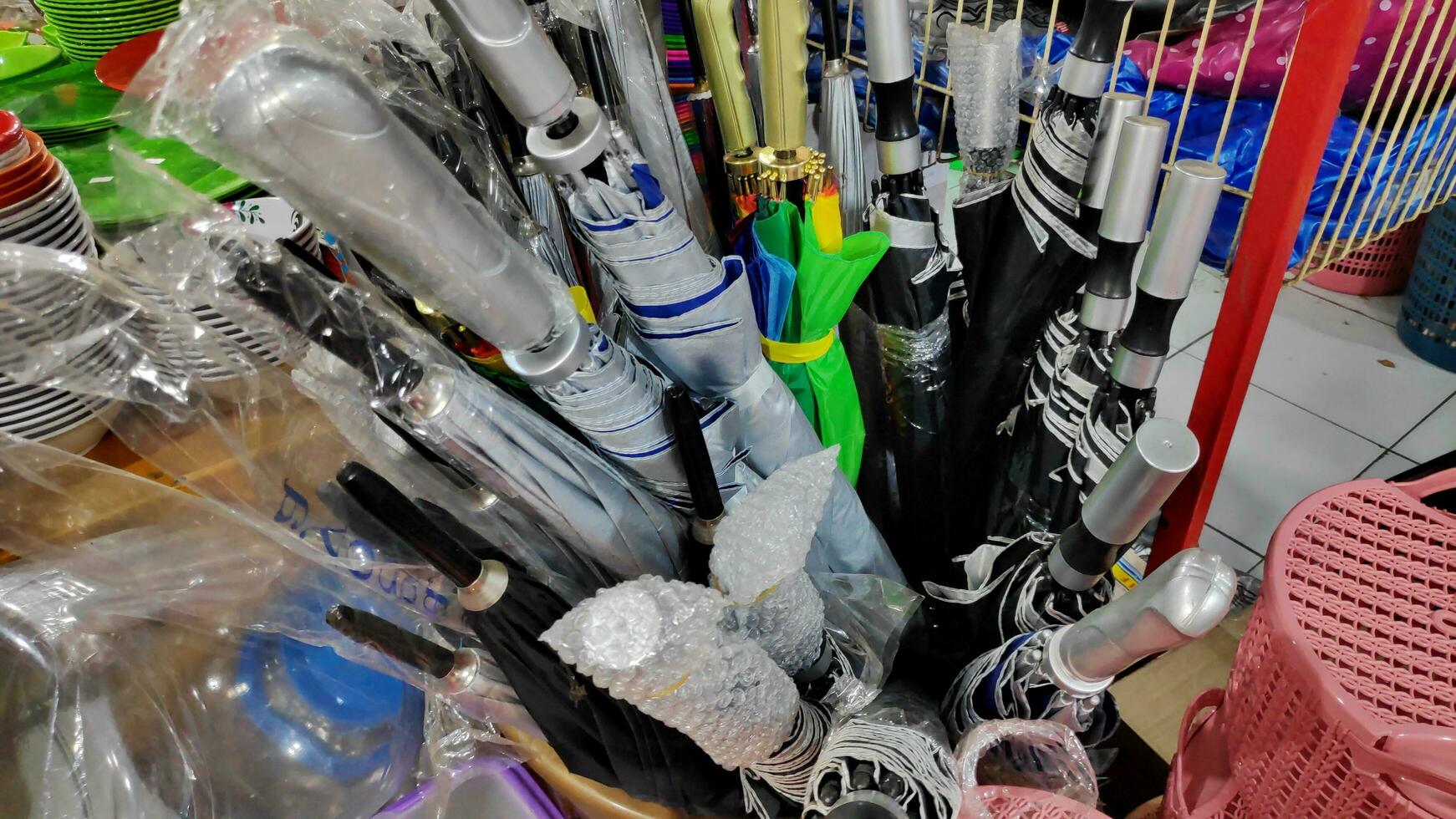 Cheap plastic household items for sale on the market close up photo