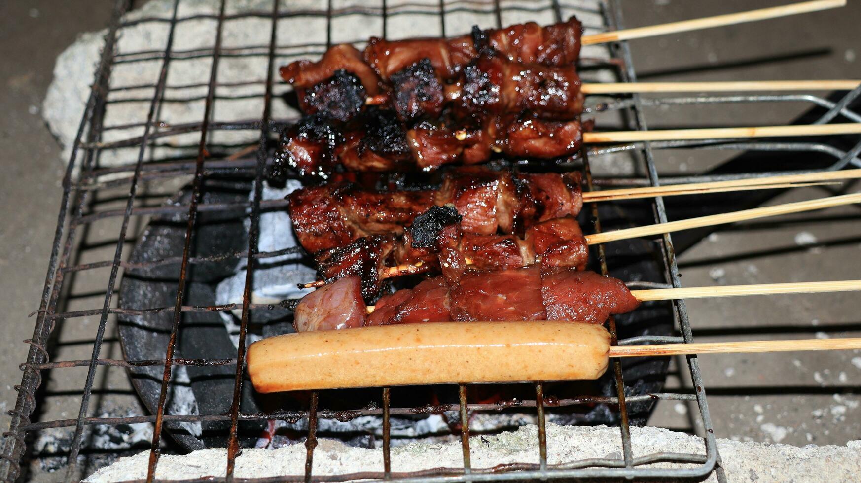 sausages and meat grilled over the fireplace with spicy soy sauce photo