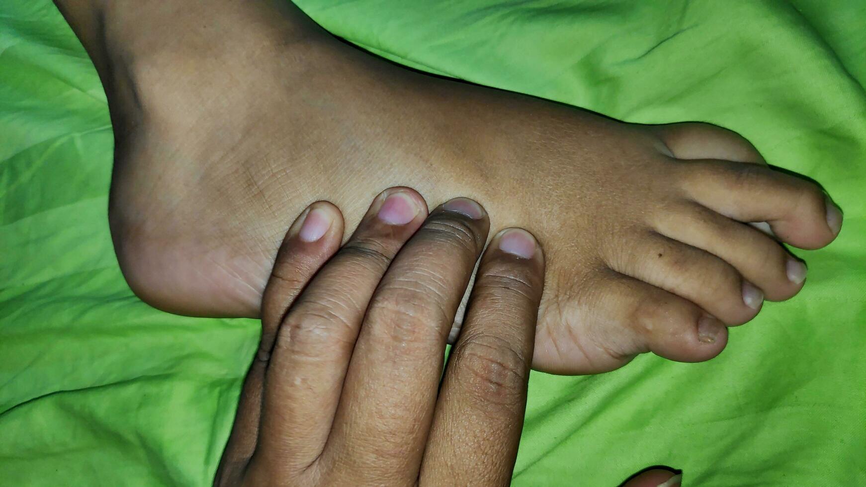 Young woman having foot massage in beauty salon, close up view photo