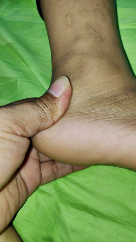 Young woman having foot massage in beauty salon, close up view photo