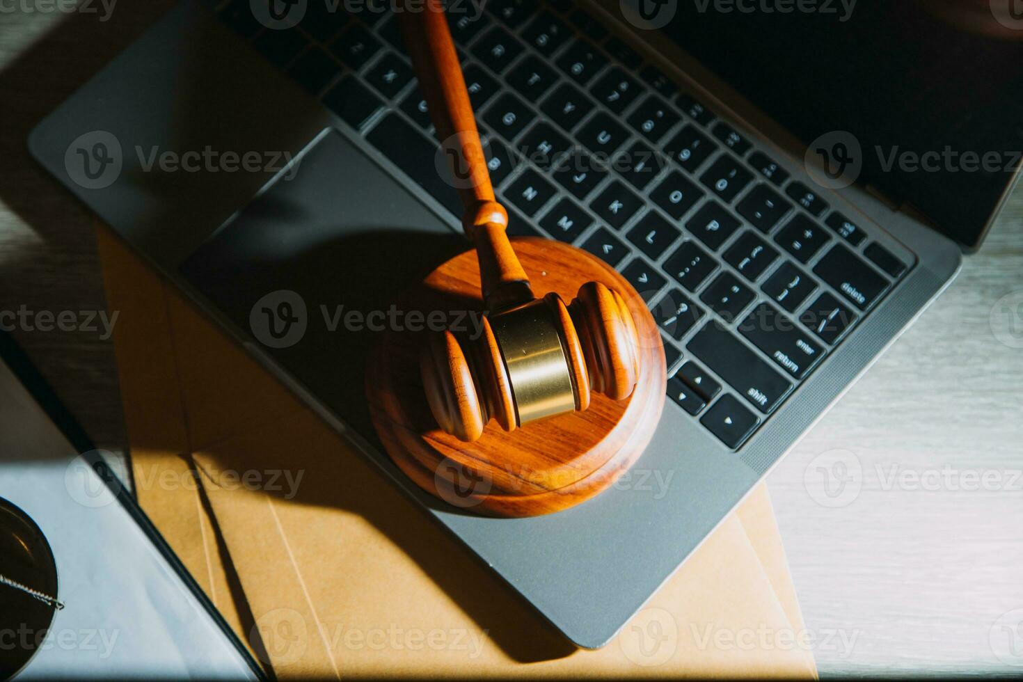 law legal technology concept. judge gavel on computer with scales of justice on desk of lawyer. photo