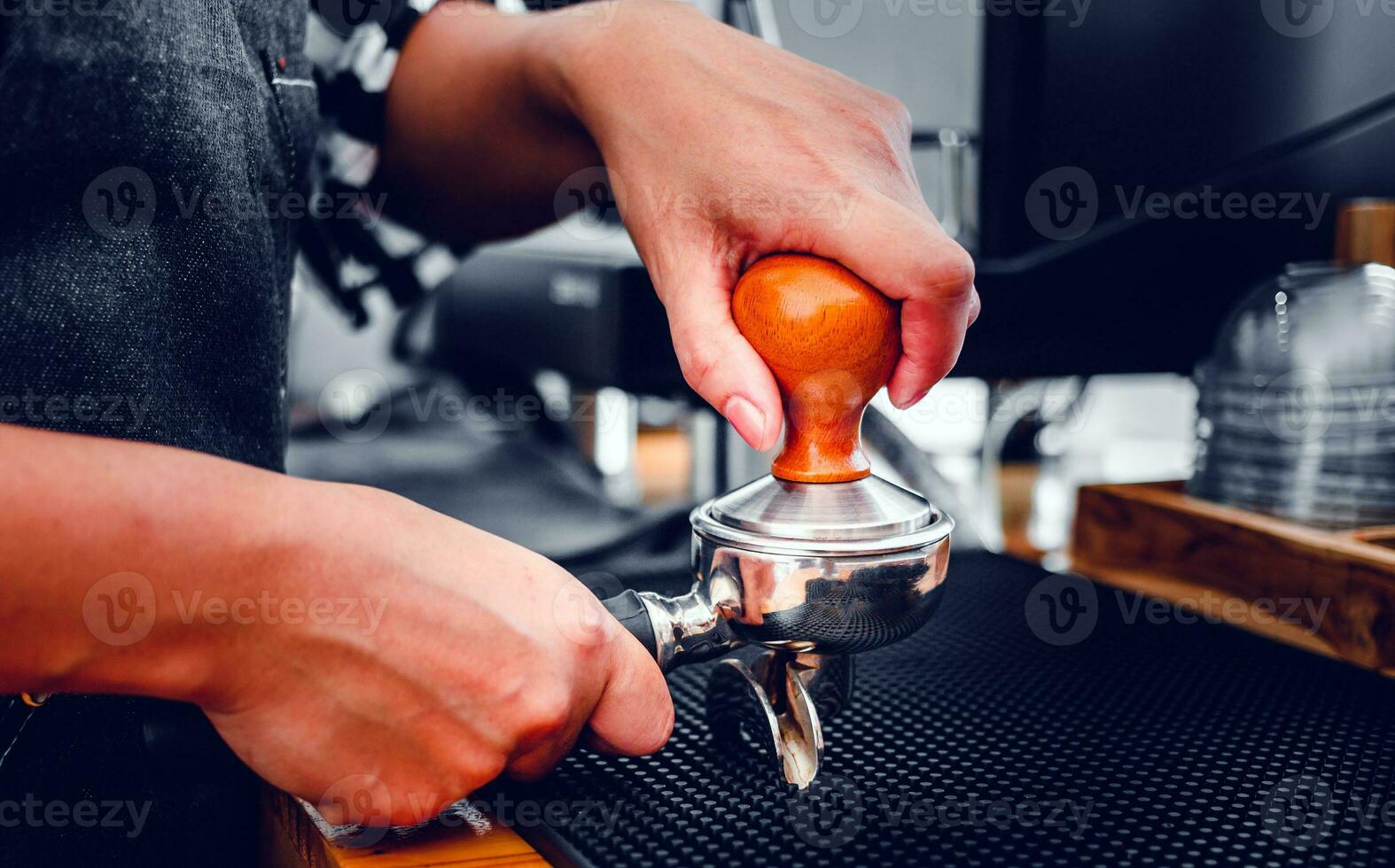 Close-up of hand Barista cafe making coffee with manual presses ground  coffee using a tamper at the coffee shop 27393541 Stock Photo at Vecteezy