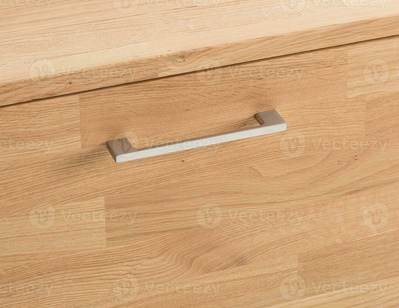 Wooden drawer with a handle close view photo, wooden furniture elements background. Furniture details photo