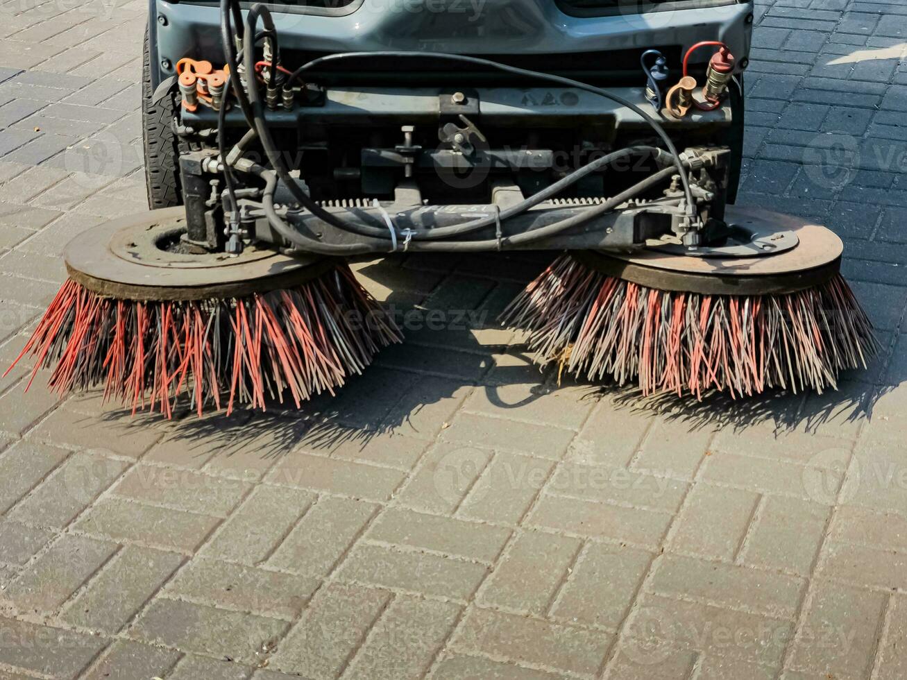 Broom of Road Sweeper Car Machine Close-up. Concept clean streets from debris. photo
