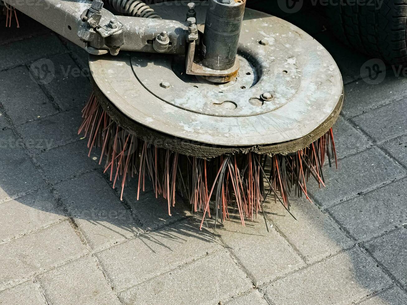 Broom of Road Sweeper Car Machine Close-up. Concept clean streets from debris. photo