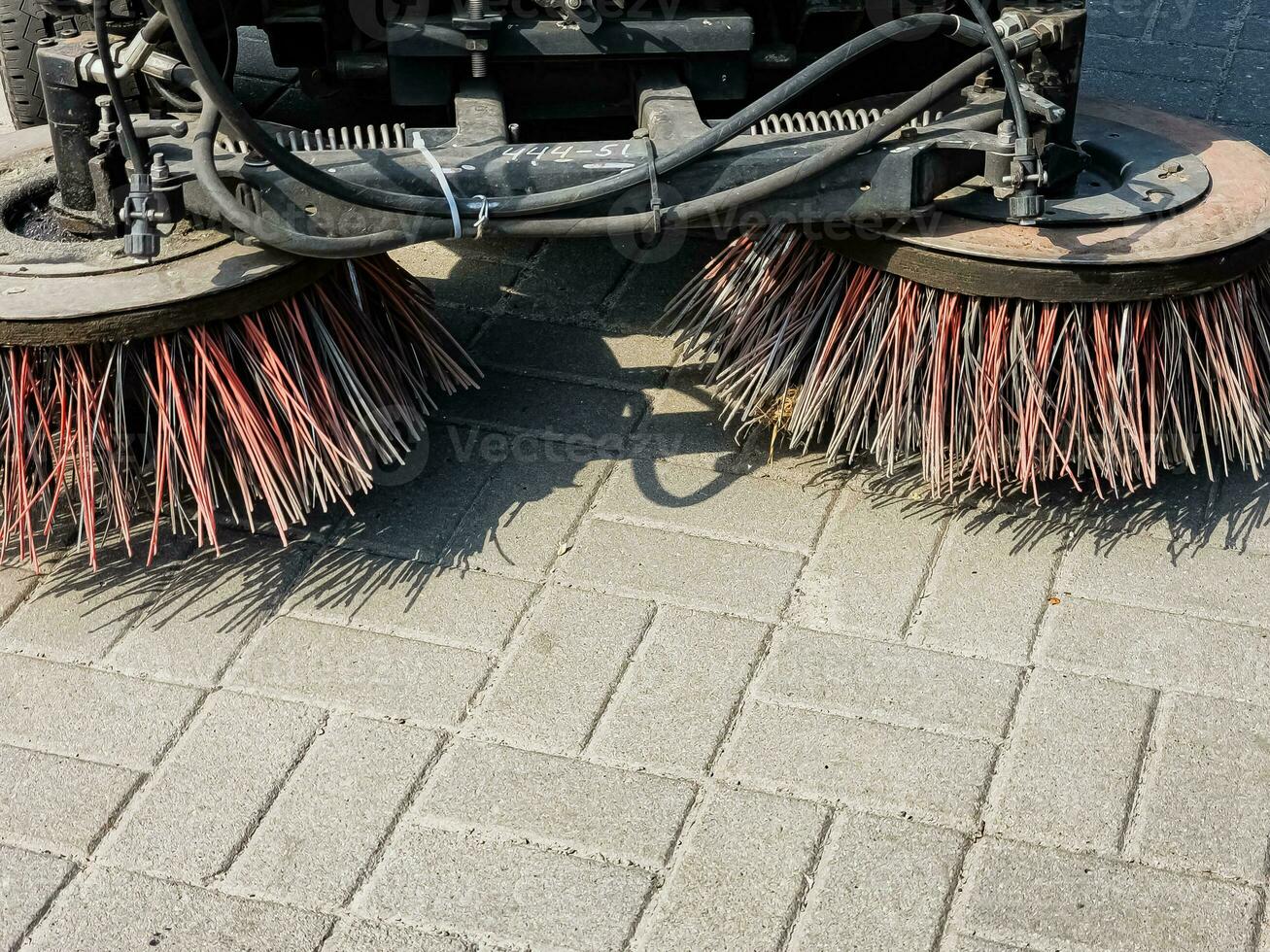 Broom of Road Sweeper Car Machine Close-up. Concept clean streets from debris. photo