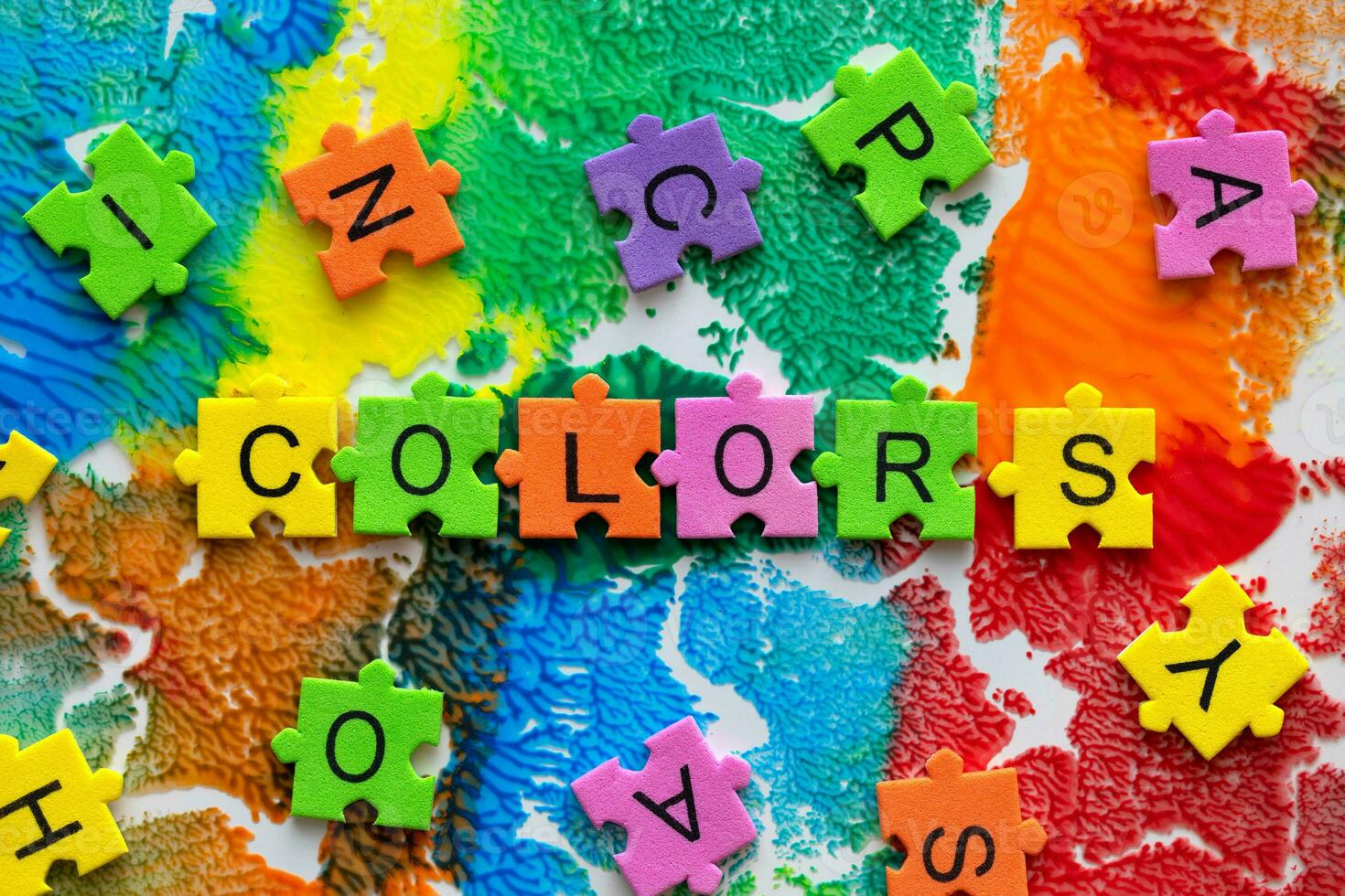 colorful puzzle pieces spelling the word colors photo