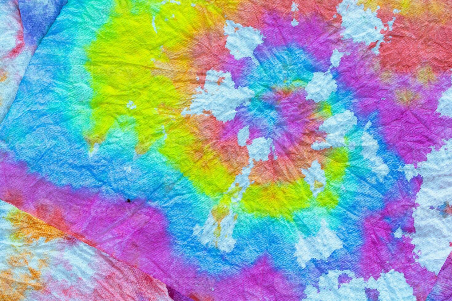 a tie dye fabric with a colorful swirl photo