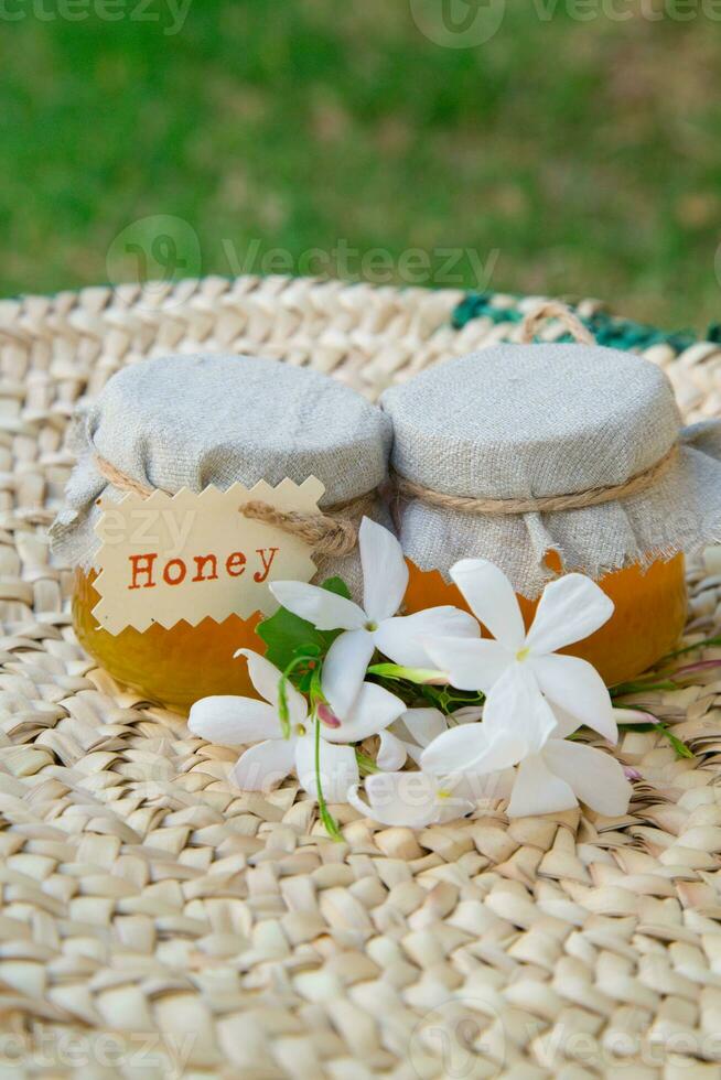 two jars of honey with a label on them photo