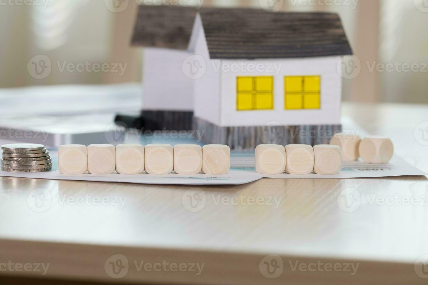 house model and coins on table photo