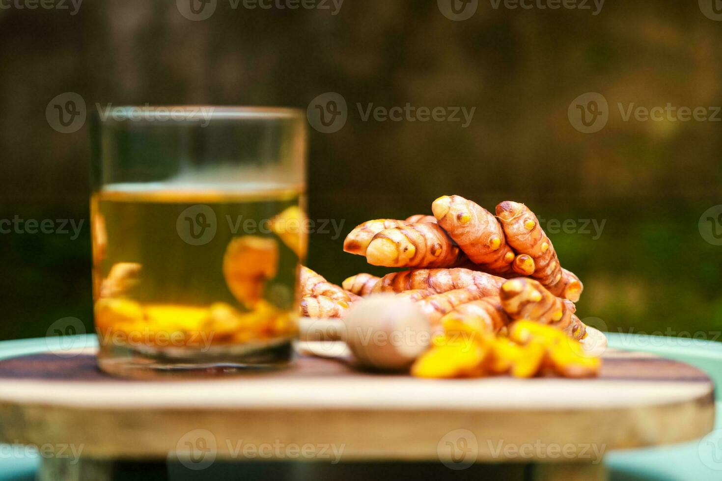 herbal drink from soaking pieces of turmeric with warm water and honey photo