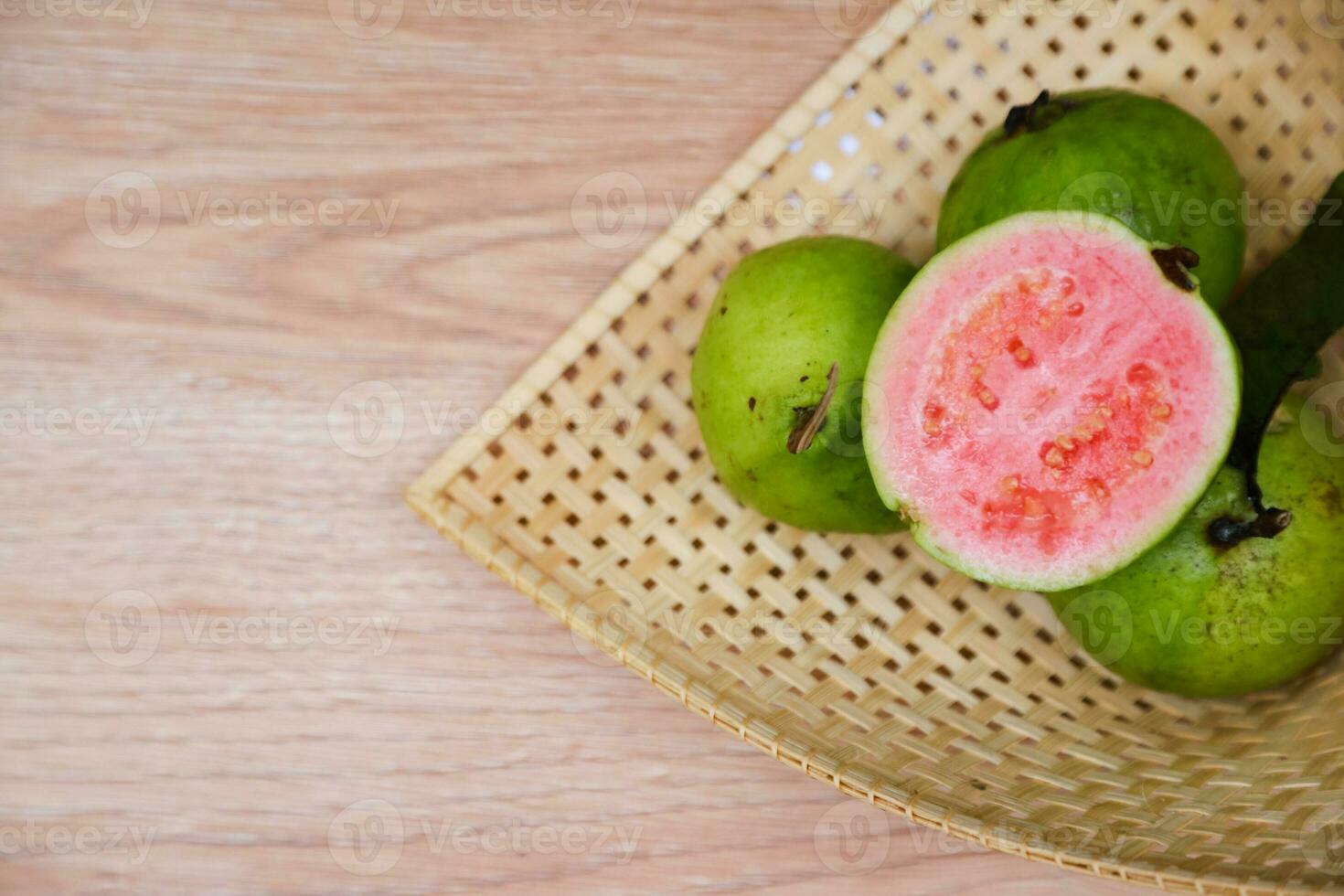 Flat lay of half cut fresh guava on the table photo