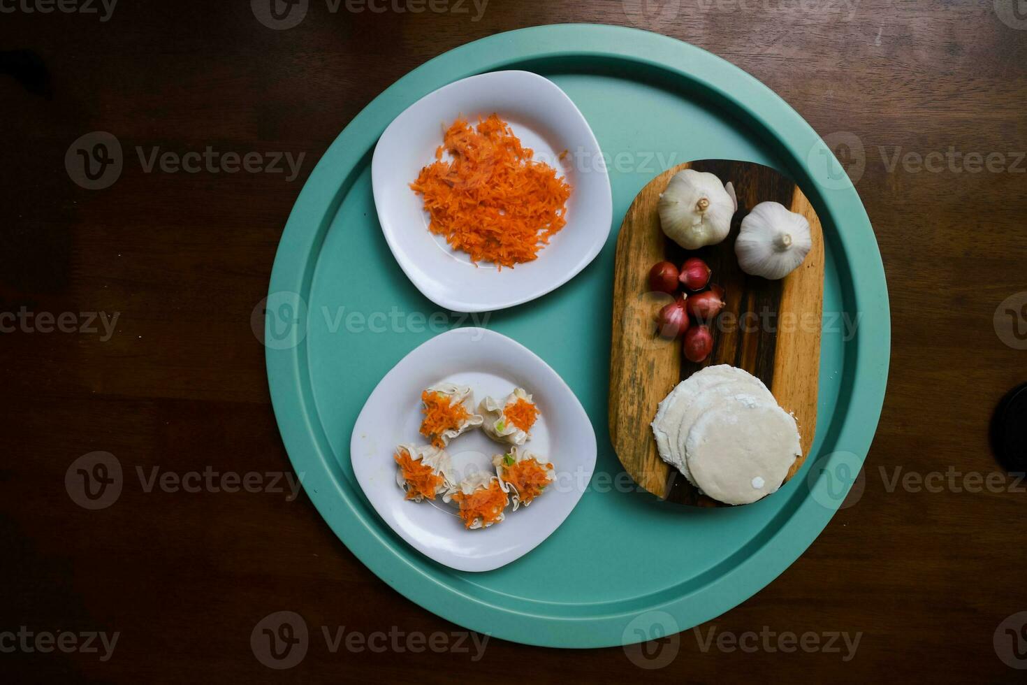 Flat lay of traditional chinese dimsum with sauce and herbs serve on a wooden table photo