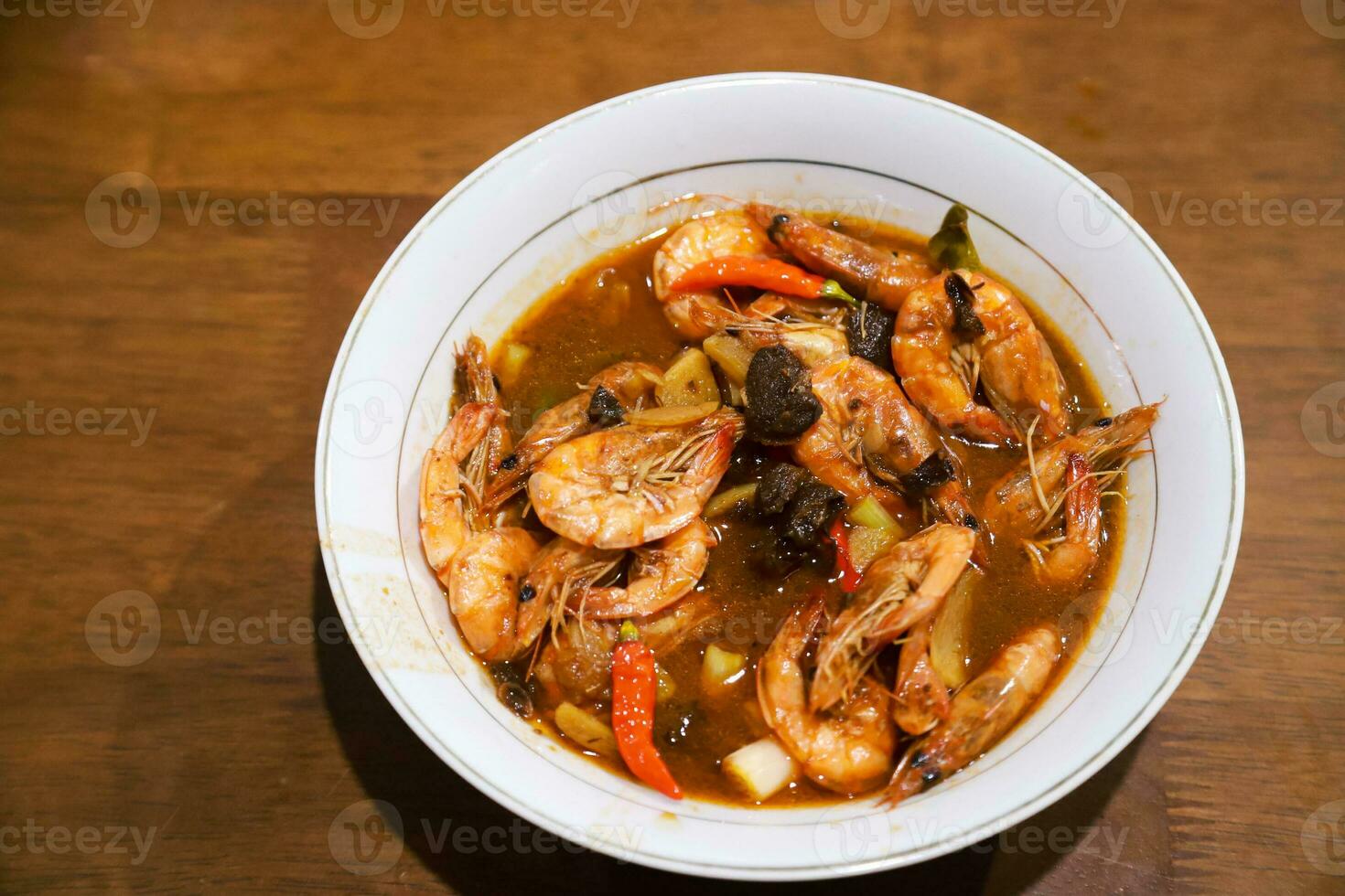sweet and sour shrimp sauce with some supporting spices served in a bowl photo