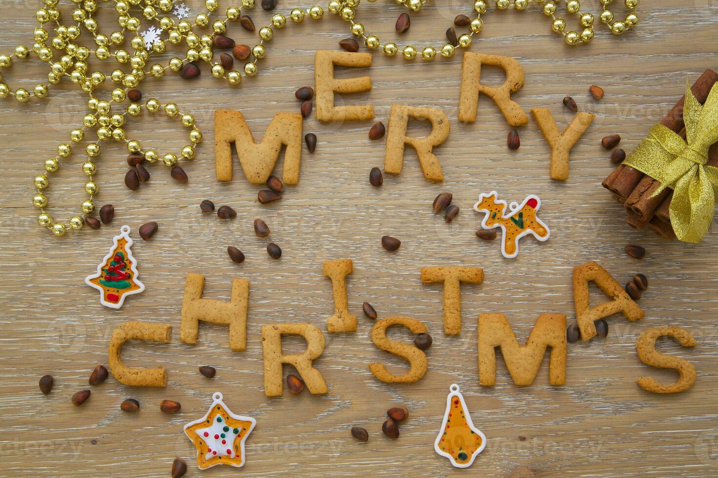 merry christmas word made of cookies and coffee beans on wooden background photo