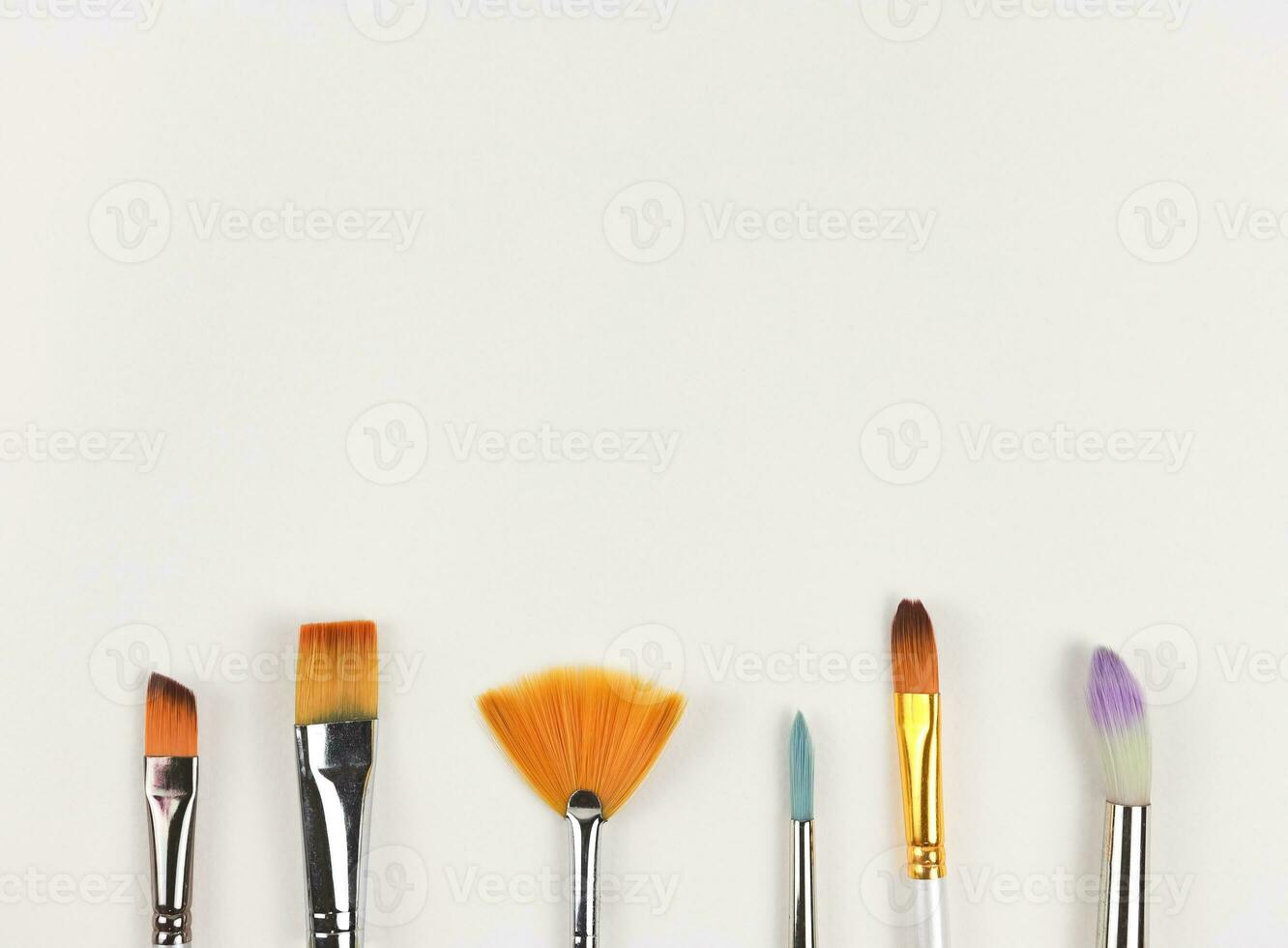flat lay of different kind of  paint brushes isolated on white background. Artist accessories. photo
