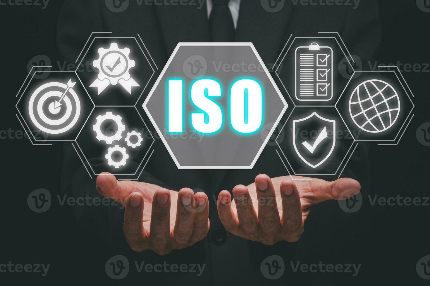 ISO standards quality control concept, Person hand holding iso icon on virtual screen on desk workplace, Assurance warranty, Business technology concept. photo