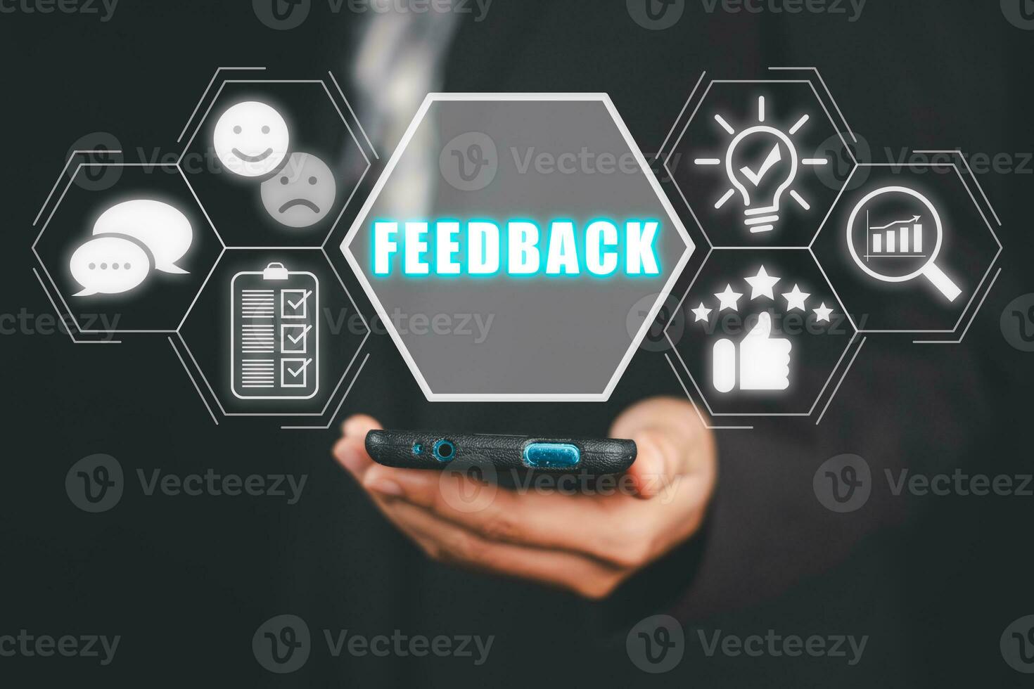 Feedback concept, Business person hand holding smartphone with feedback icon on virtual screen. photo