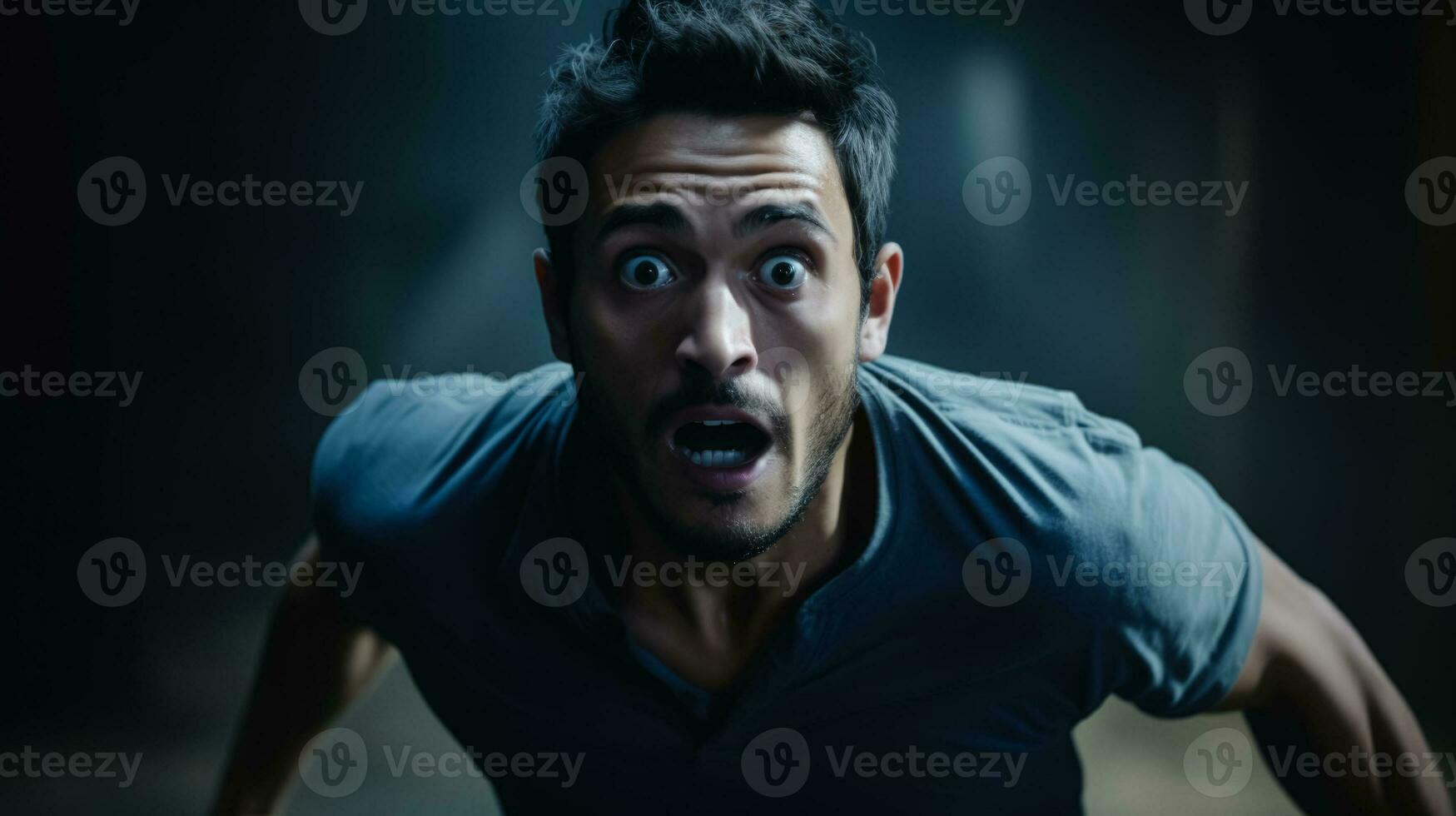 Running in slow motion shocked face of man on dark background with a place for text photo
