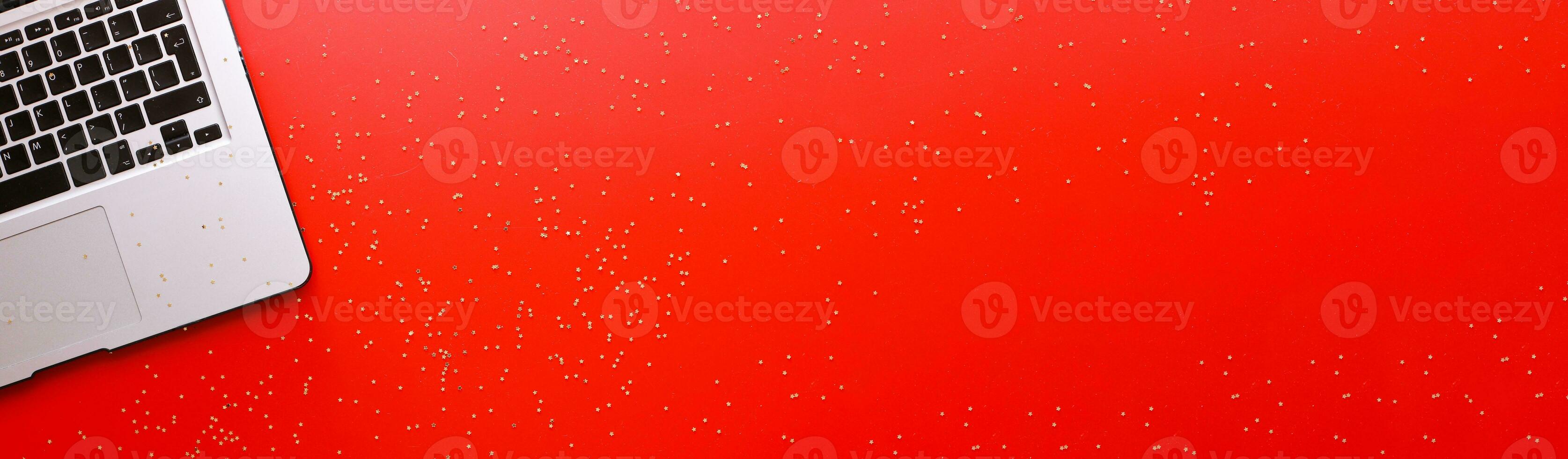 Banner Flat lay online shopping for christmas. Notebook and sparkles on red background photo