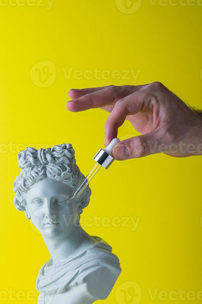 skin care oil and roman statue photo