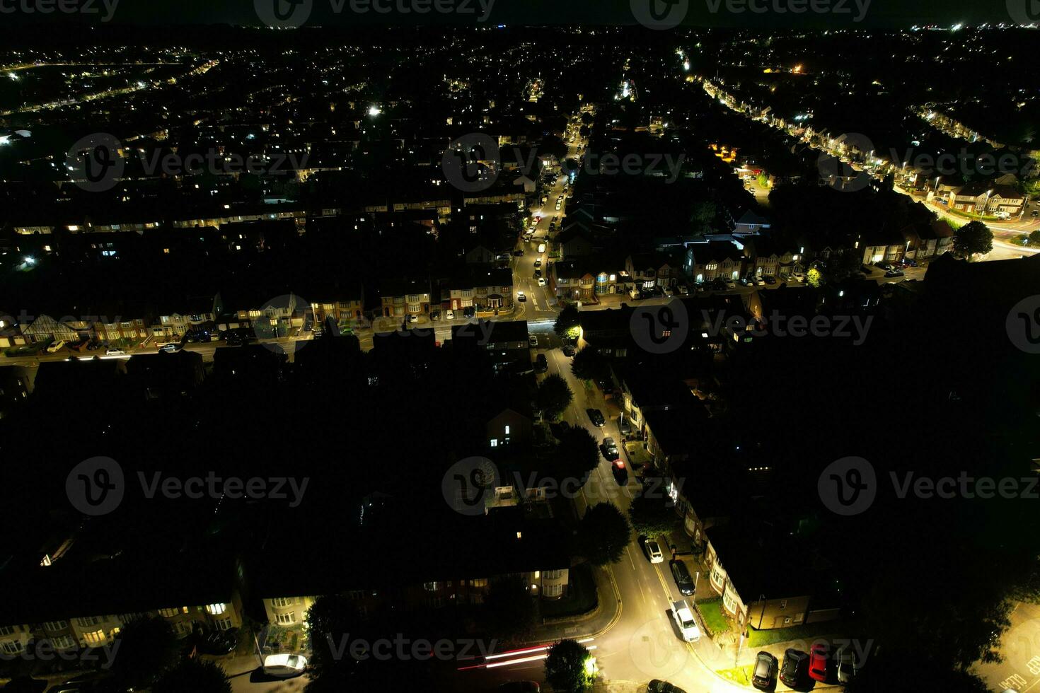 High Angle Footage of Central Luton City of England During Night. Illuminated Luton City Was Captured with Drone's Camera on August 14th, 2023 During Night photo