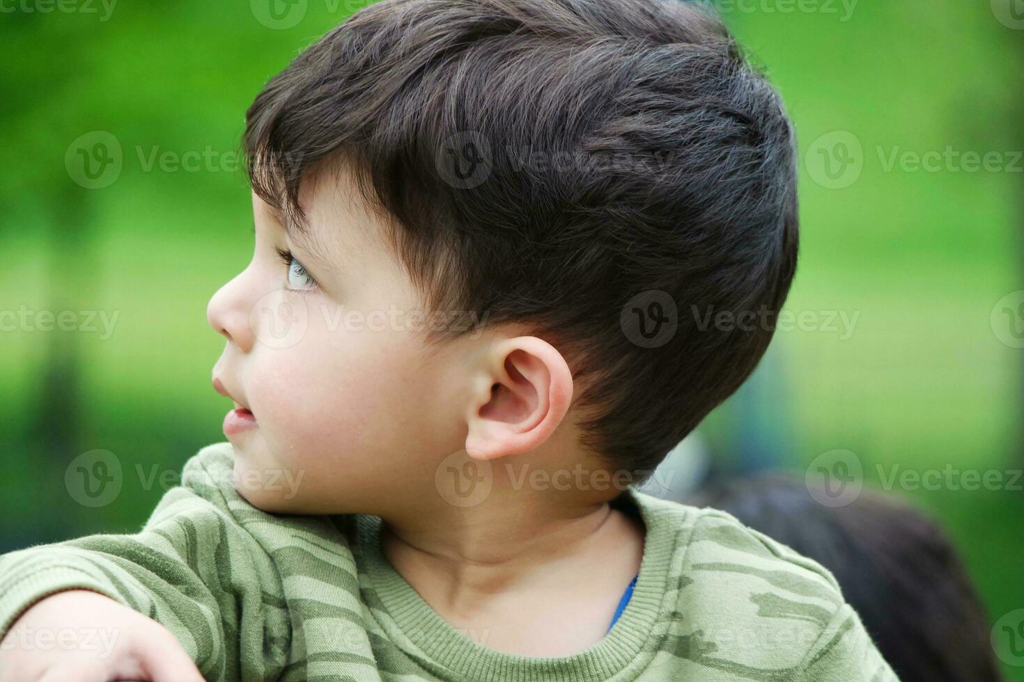 Cute Asian Pakistani Baby is Enjoying The Beautiful Sunny Day at Wardown Children and Public Park of Luton Town of England UK. Low Angle  Image Was Captured on April 03rd, 2023 photo