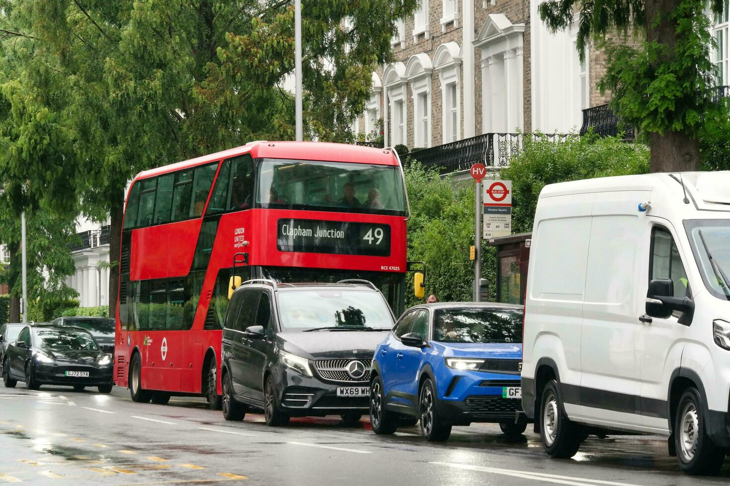 Gorgeous Low Angle view of Bus Service and British Traffic at Central London City of England UK. Image Captured on August 2nd, 2023 During Cloudy and Rainy Day. photo