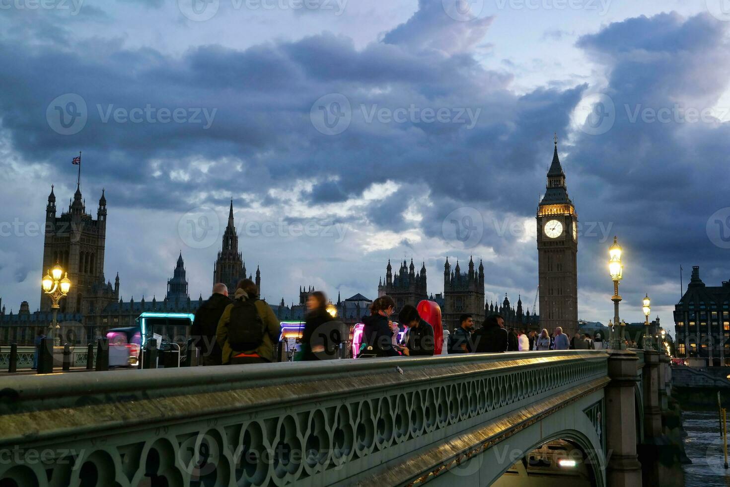 Beautiful Footage of Illuminated British Road at London eye from River Thames Westminster, Big Ben clock Tower at After Sunset Night. England Great Britain,  Footage Was Captured on Aug 02nd, 2023 photo