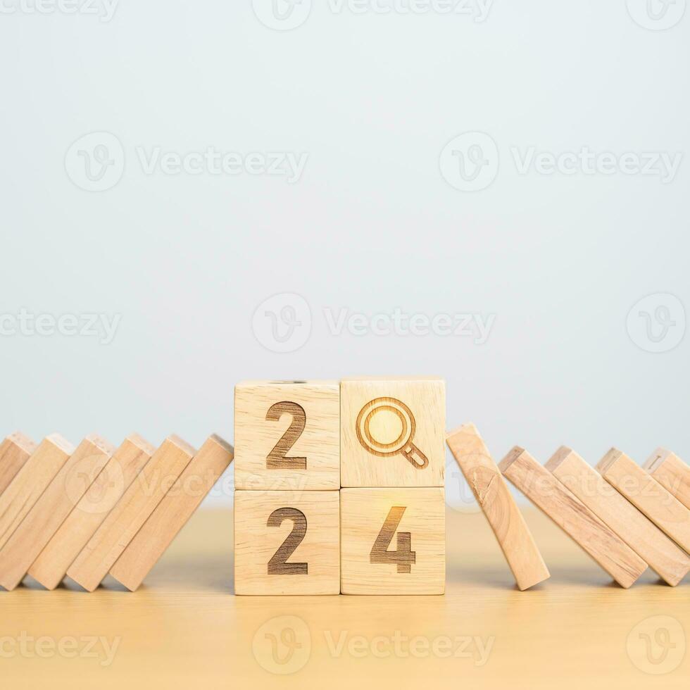 2024 year and falling blocks with magnifying glass icon. SEO, Search Engine Optimization, hiring , Advertising, Risk Management, recession, goal, New Year planning and inflation economy concepts photo
