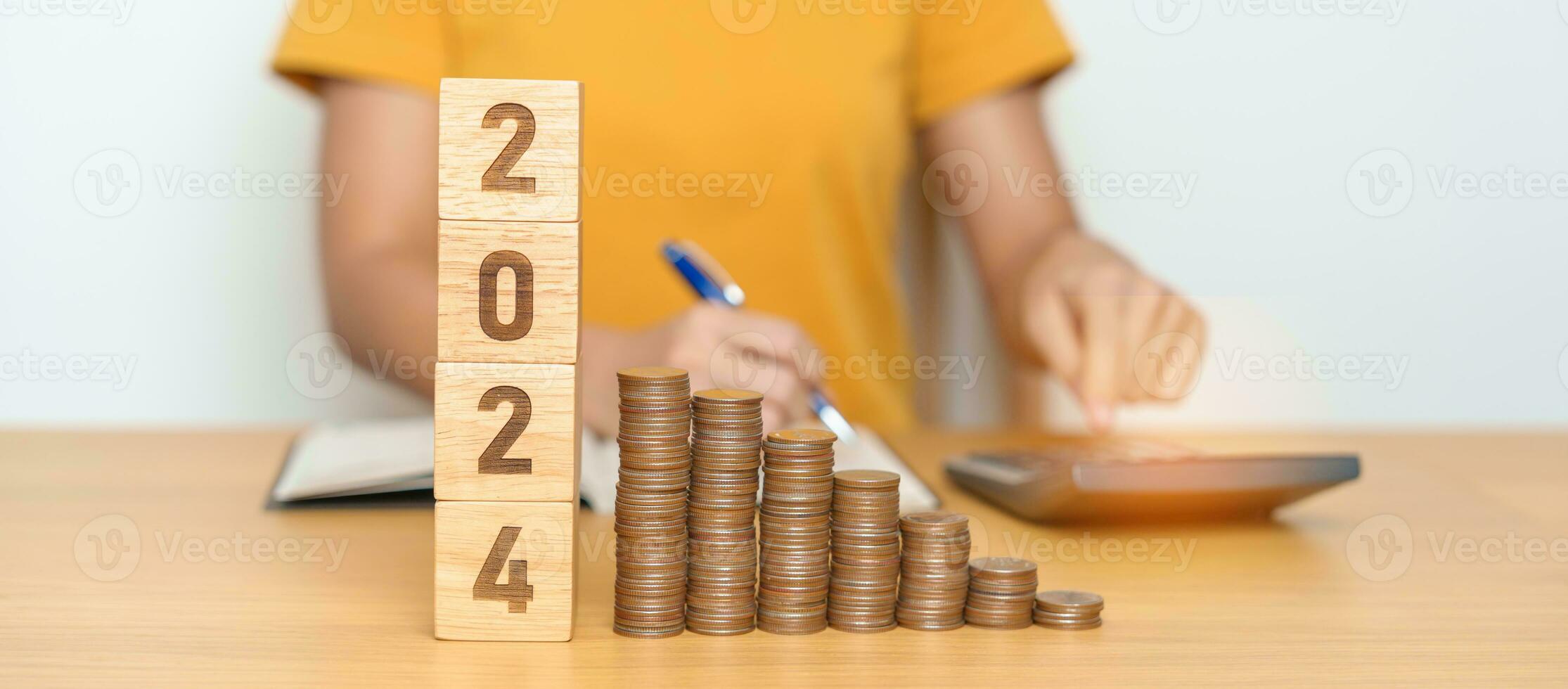 2024 year block with Coins stack. Money, Budget, tax, investment, financial, savings and New Year Resolution concepts photo