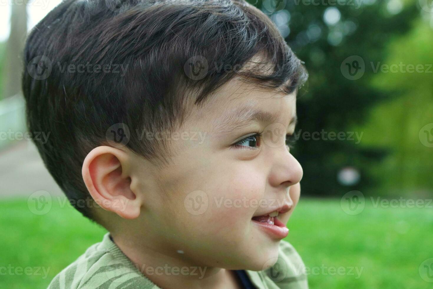 Cute Asian Pakistani Baby is Enjoying The Beautiful Sunny Day at Wardown Children and Public Park of Luton Town of England UK. Low Angle  Image Was Captured on April 03rd, 2023 photo