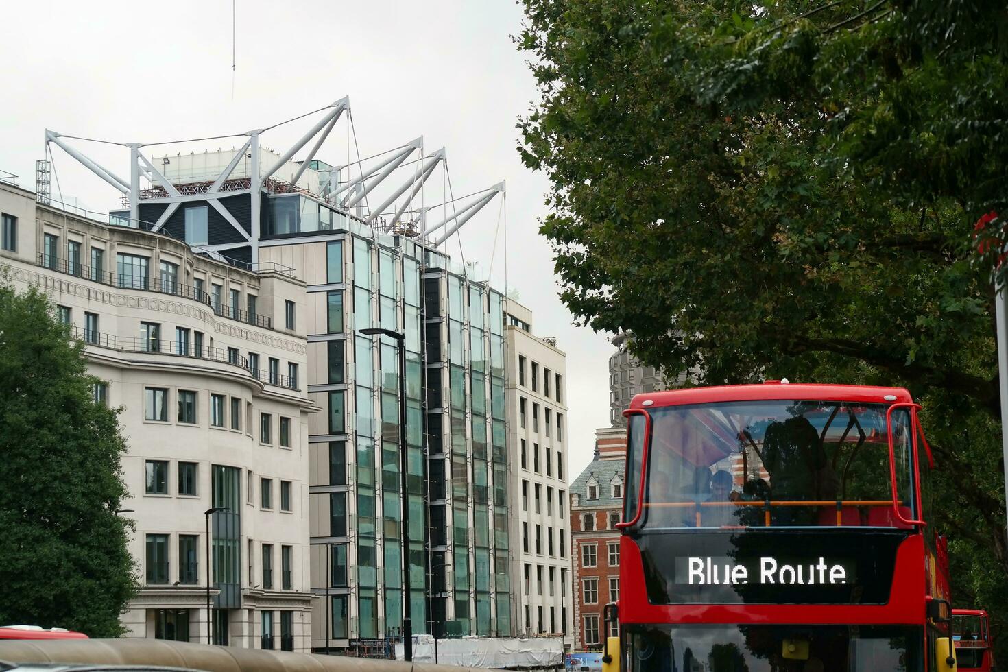 Gorgeous Low Angle view of Bus Service and British Traffic at Central London City of England UK. Image Captured on August 2nd, 2023 During Cloudy and Rainy Day. photo