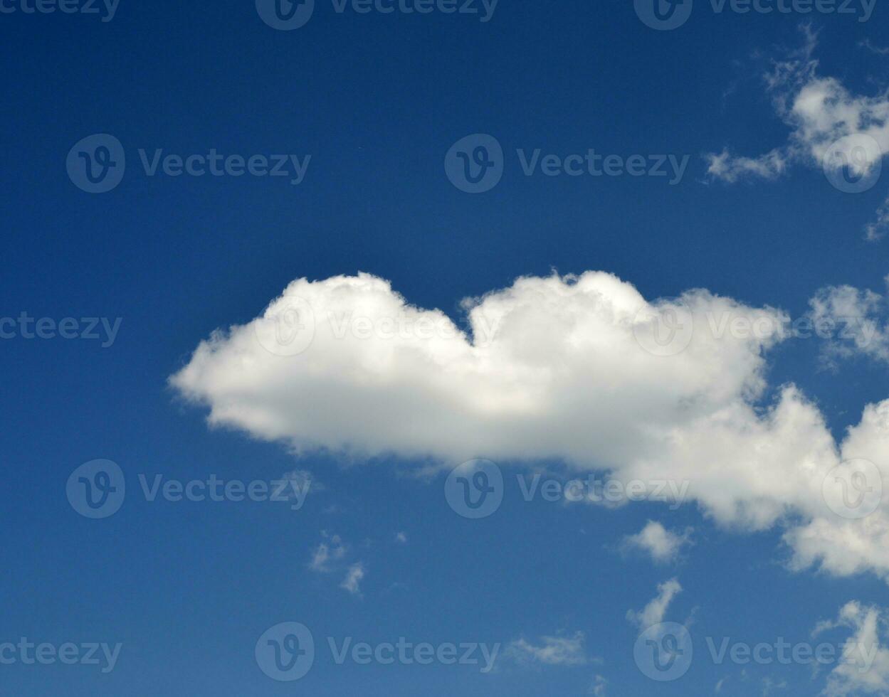 Single clouds in blue sky photo